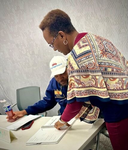 Apryl Munyanshongore, a homeownership coach with KNHS, helps a prospective homeowner during a Jan. 19, 2023, session of the Home Buyer Education Program.