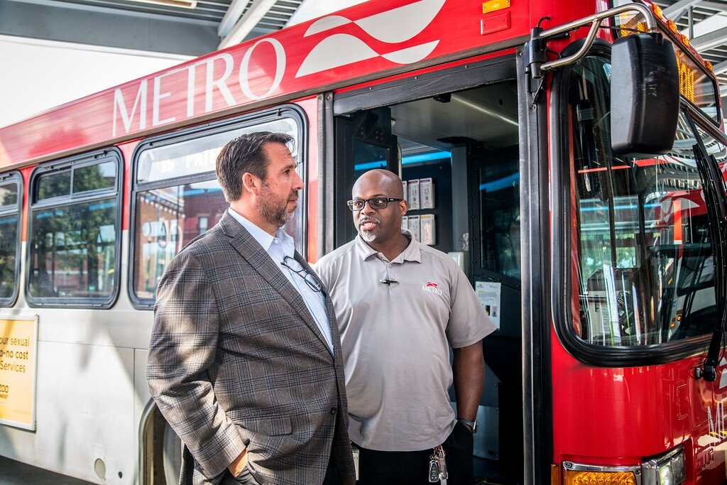 Sean McBride, executive director of Metro Transit, left, speaks with Coach Operator Michael Jackson.