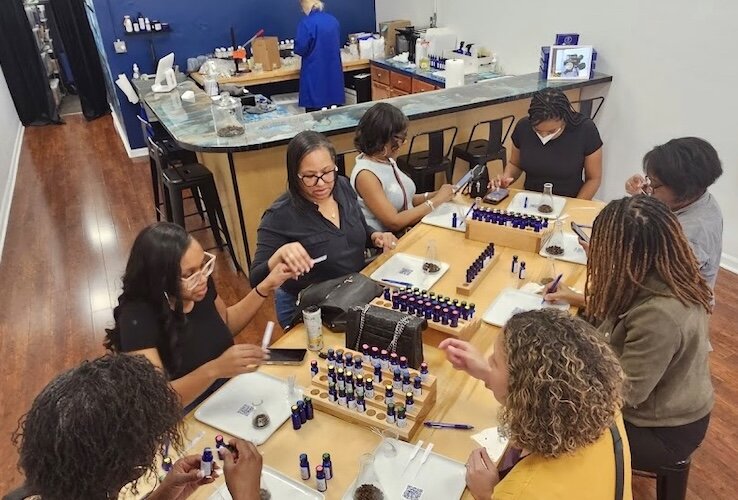 A group of women create their own fragrances inside The Aroma Labs location at 352 S. Kalamazoo Mall in downtown Kalamazoo.
