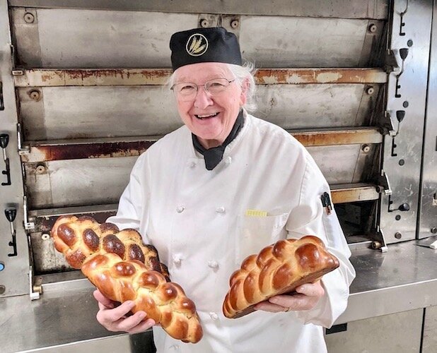 Judy Sarkozy holds two loaves of Challah bread inside Sarkozy Bakery and Cafe in downtown Kalamazoo. She says she didn’t know anything about business when she started 44 years ago so she’s happy entrepreneurs now have Can-Do Kalamazoo.