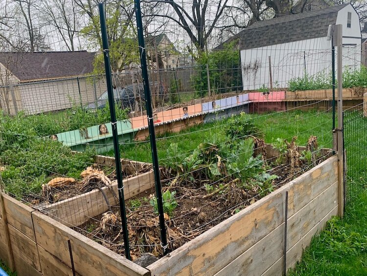 Drawings of young people who have been involved in Mothers of Hope’s piano program adorn the perimeter of its backyard garden.