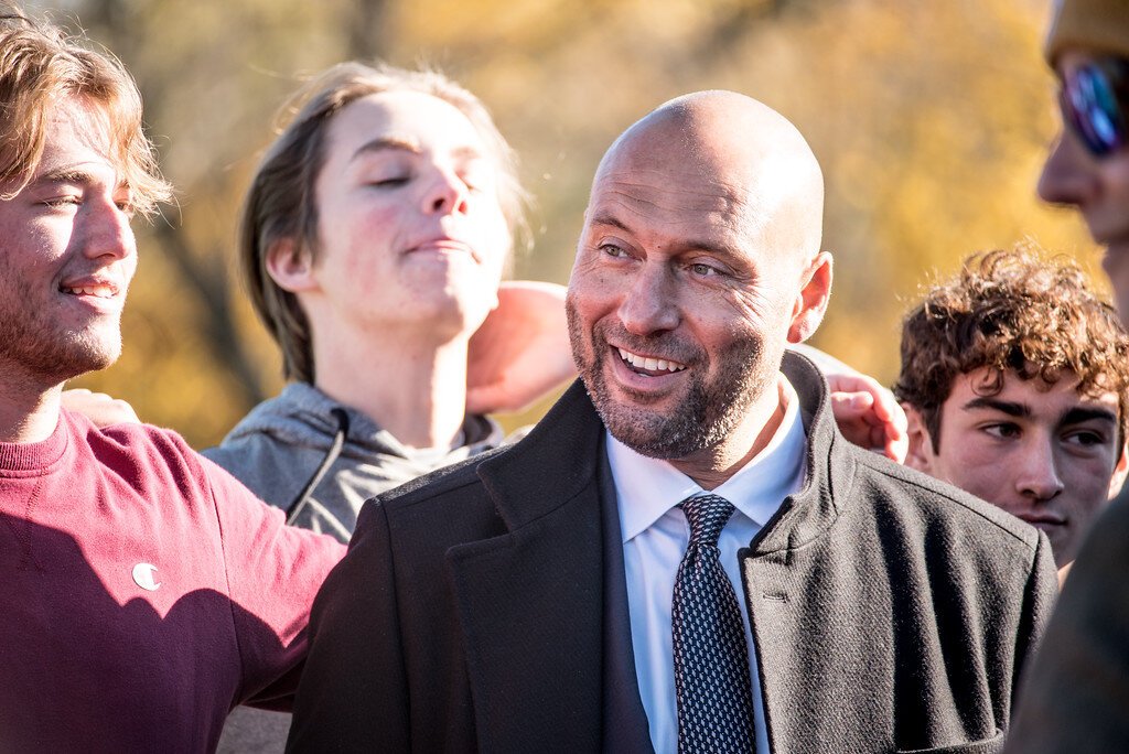 Baseball great Derek Jeter is surrounded by members of the Kalamazoo Central High School baseball team during his Tuesday, Nov. 14, 2023, return to his alma mater.