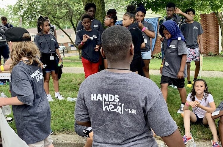 Young people make posters that call attention to life without violence during Urban Alliance’s summer Life Camp.