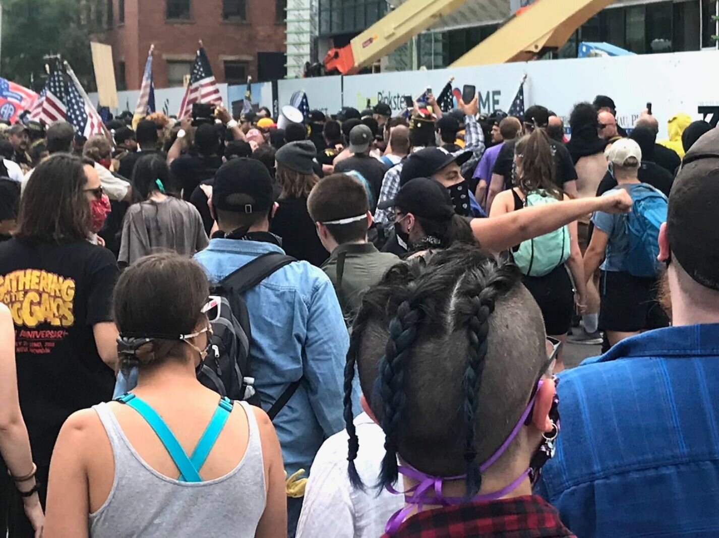 Counter-protesters, foreground, begin to clash with members of the Proud Boys, background, at the intersection of water Street and Edwards Street.