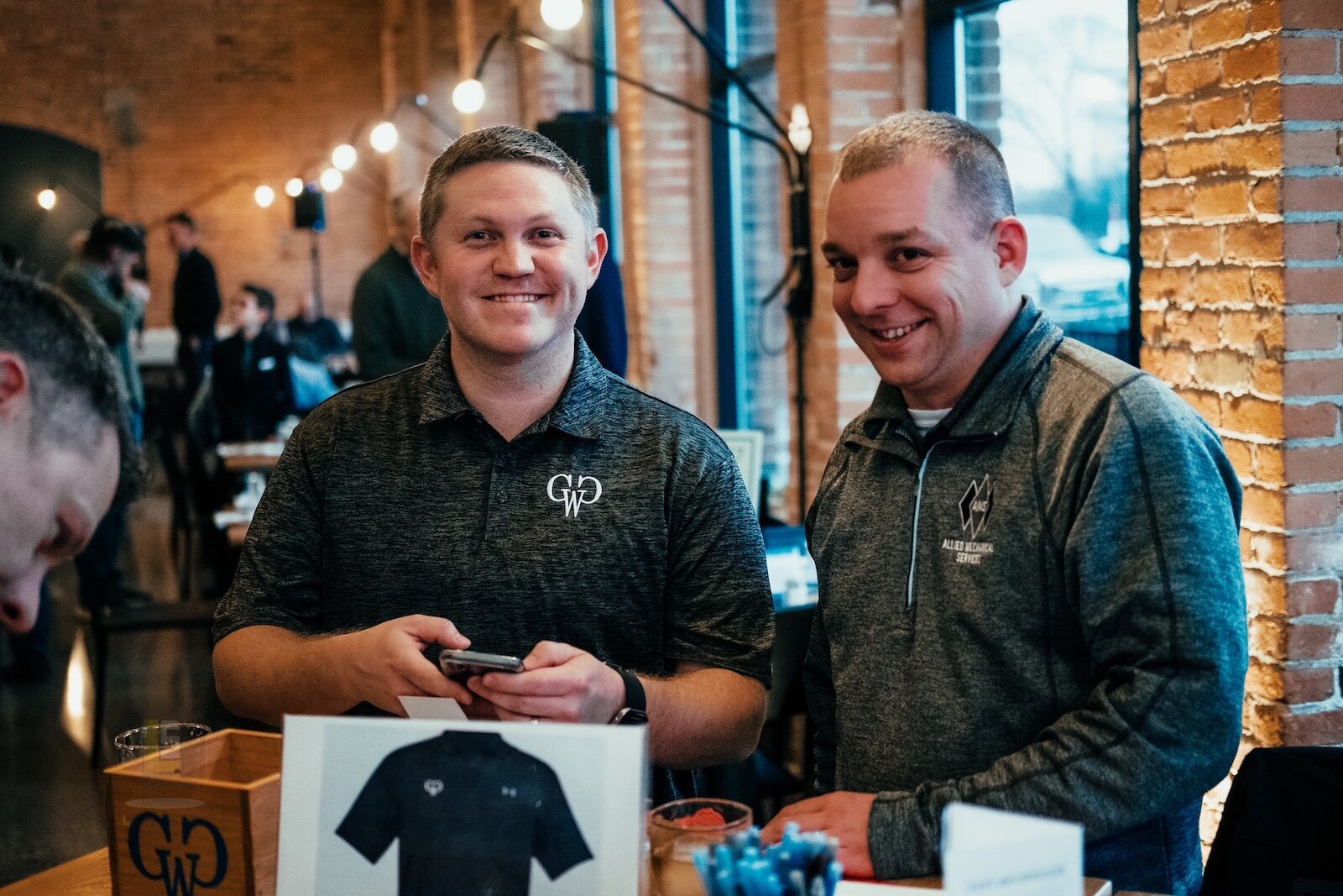 Cody Livingston, left, and Tim Evans get things organized at a 2019 meeting of Guys Who Give.