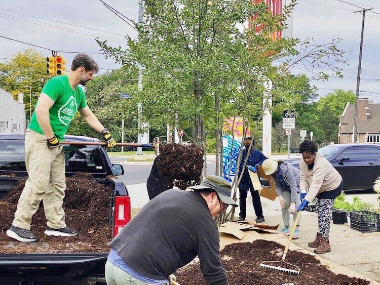 Edison Neighborhood residents are shown preparing a small section of greenspace for planting in spring of 2022 as part of the Edison Neighborhood’s environmental sustainability effort called Grow Edison.