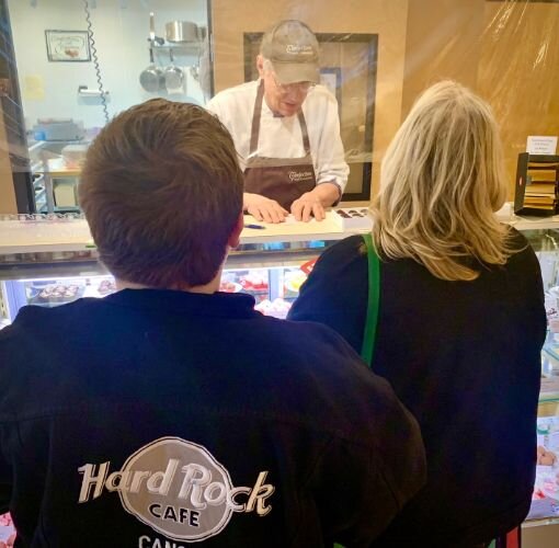 Dale Anderson, shown helping customers Kalten and Kelly Alkema on Tuesday, Feb. 7, 2023, says Confections with Convictions has been helped by word-of-mouth and mentions on social media.