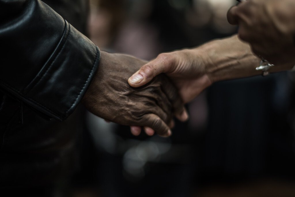 Elizabeth Washington,  new executive director of the NACD, shakes hands with a neighborhood resident at NACD’s, March 1, 2024 open house.