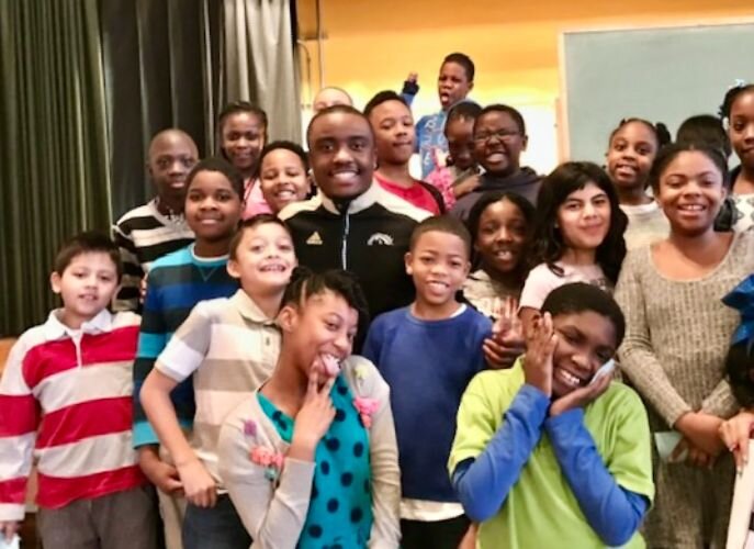 Real estate developer Jamauri Bogan stands with a group of children he help mentor while he attended Western Michigan University.