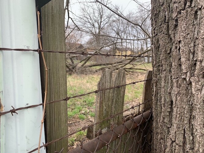 Vacant property in the 400 block of West Ransom Street is to be used to build four single-family houses. Looking north, it can be seen through a wooden fence with barbed wire.