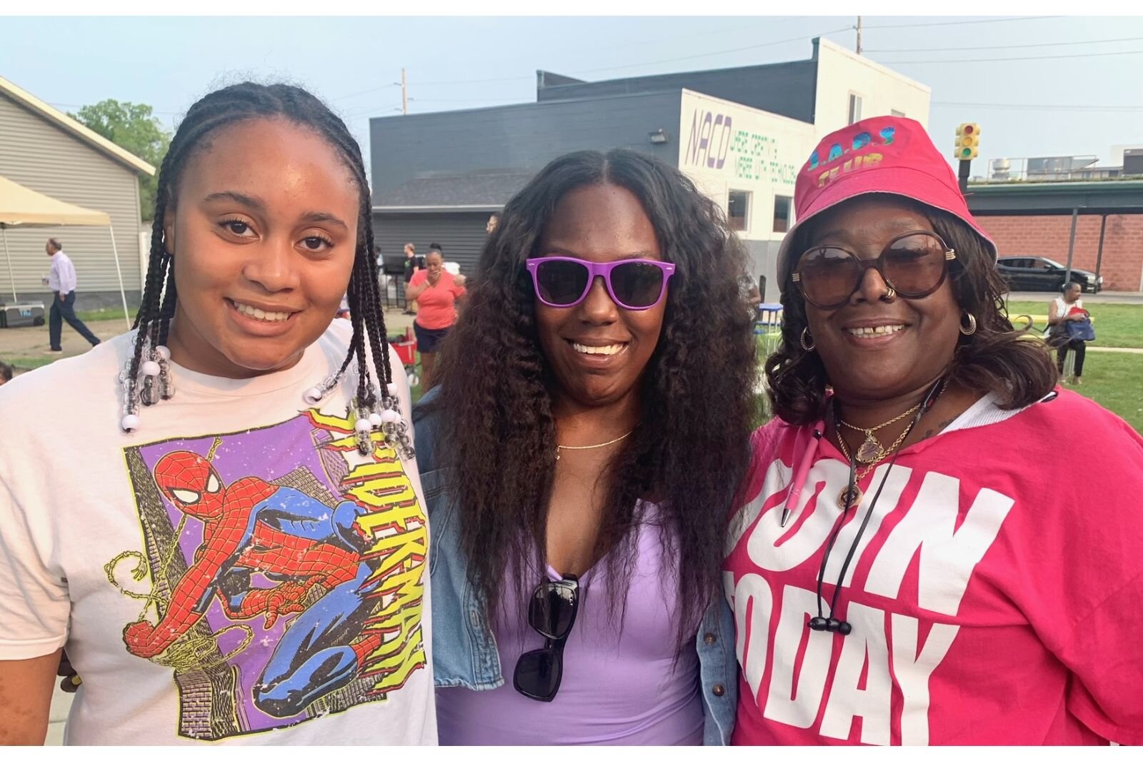 Kalamazoo City Commissioner Tami Rey, center, Hope Thru Navigation Executive Director Gwendolyn Hooker, right, and Rey’s niece Simone Moore, left, participate in the Northside Neighborhood’s National Night Out.