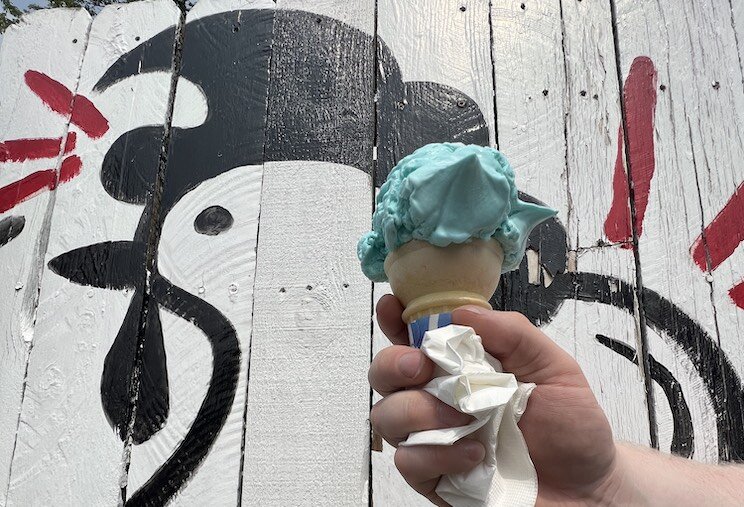 Blue moon ice cream backdropped by Chicken House's mural.