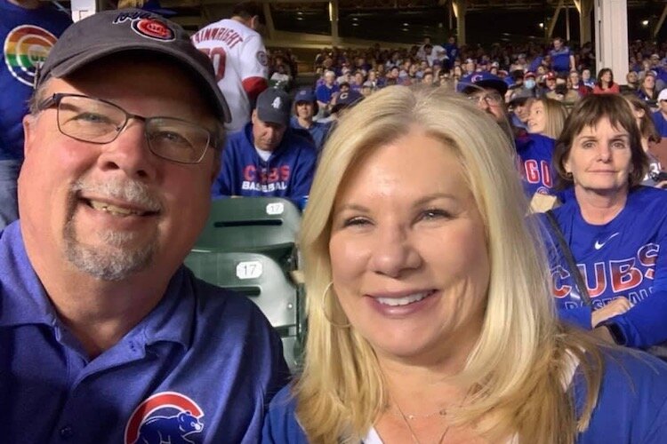 Larry Bell, shown with wife Shannon at a Chicago Cubs game, says he intends to continue to help the Kalamazoo community.