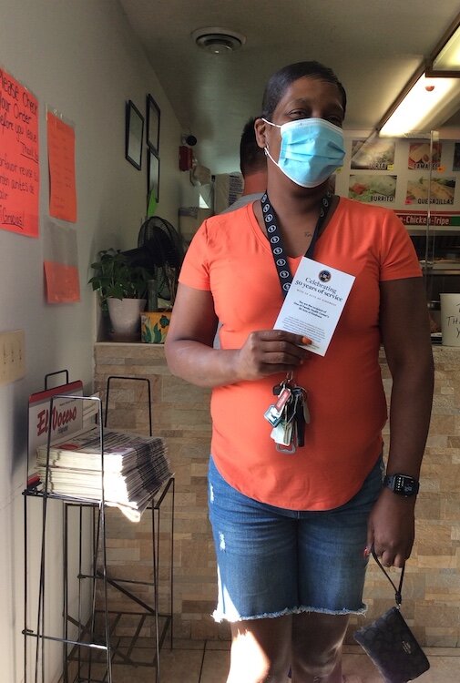 A patron of Los Brothers restaurant shows a “Thank You” card she received along with a free lunch Wednesday from the Familly Health Center.