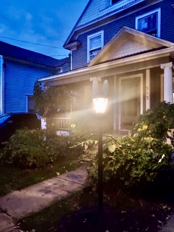 Solar-powered lamp posts, such as the one seen here, help deter unwanted foot traffic at night as well as add a little curb appeal to homes.