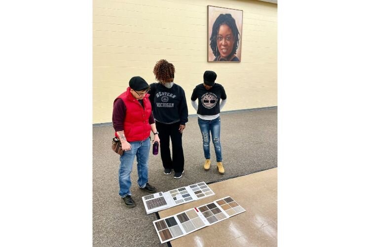 Volunteers look at color palettes that will be used to upgrade the interior of the Douglass Community Association.