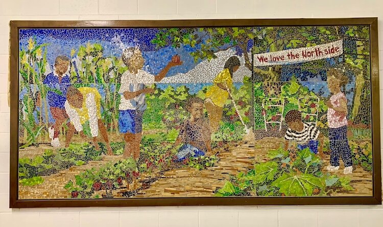 A framed mosaic in the meeting room of the Northside Association for Community Development, at 612 N. Park St., states: “We love the North Side.”