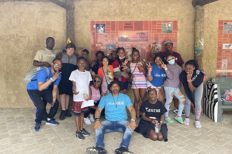 Damon Brown, founder and president of R.I.S.E., poses with a group of the students he and team work with.