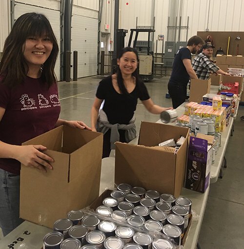 Third-year students Terrence Li, Marine Bolliet, and Kelsey Miller volunteered at Kalamazoo Loaves and Fishes.