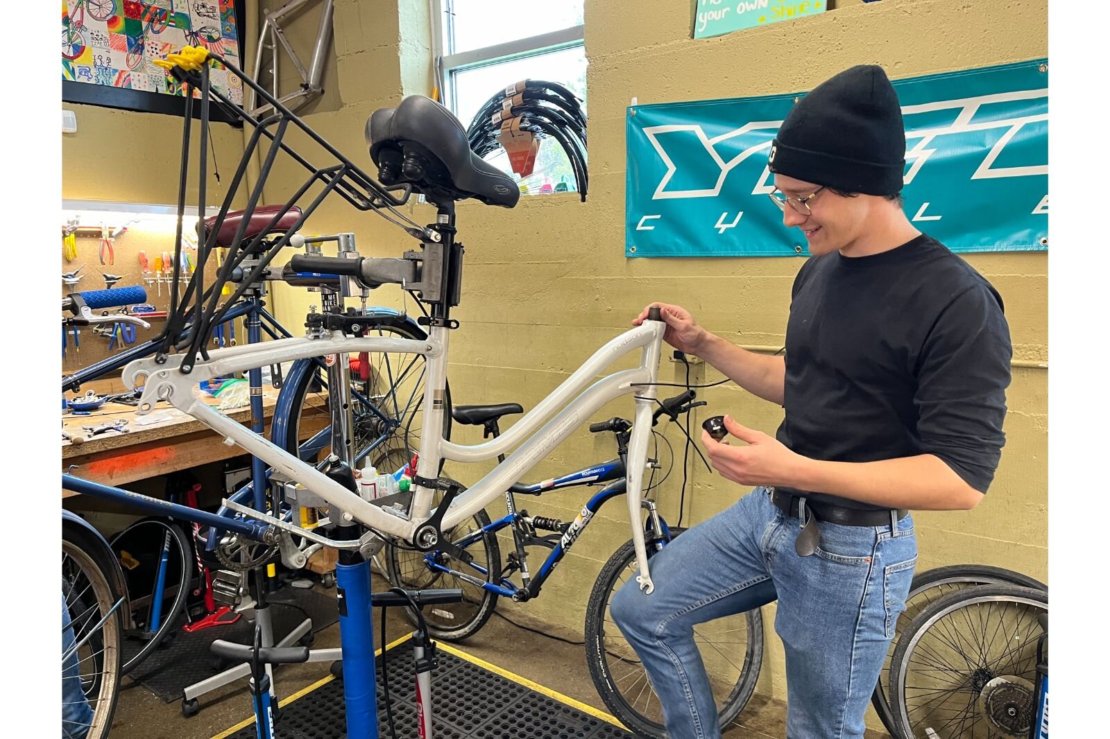 Ian Smith working on a bike in Open Roads shop. Open Roads provides space, tools and knowledge to Dignity in Motion's bike program.