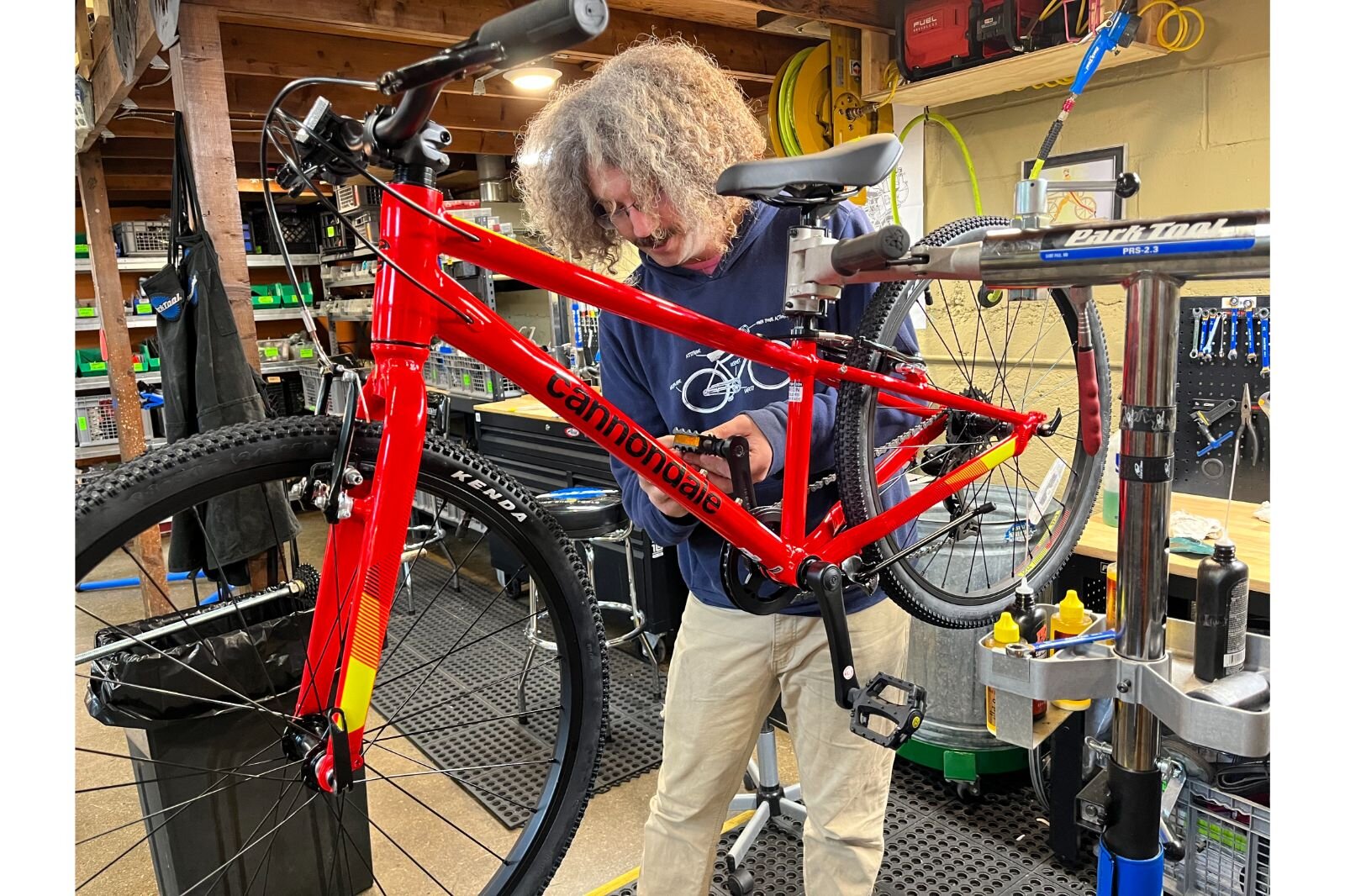 Issac Green works on a bike in Open Roads shop. Open Roads provides space, tools and knowledge to Dignity in Motion's bike program.