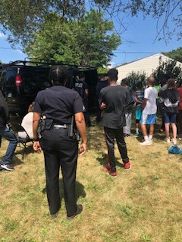 Battle Creek Police Officers and youth participate in a Police Athletic League and New Level Sports event in the summer of 2019,