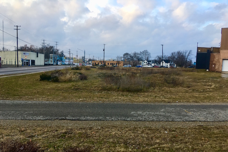 Work to build a three-story residential/commercial project off the southeast corner of Lake and Portage streets could begin early this year. The site is shown from its southernmost point, looking north. Portage Street is to the left in this image.