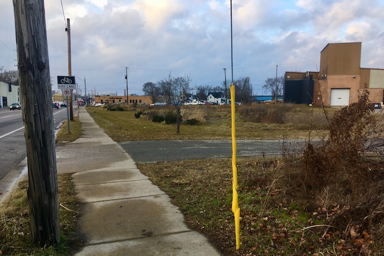 Work to build a three-story residential/commercial project off the southeast corner of Lake and Portage streets could begin early this year. The site is shown from its southernmost point, looking north. Portage Street is to the left in this image.