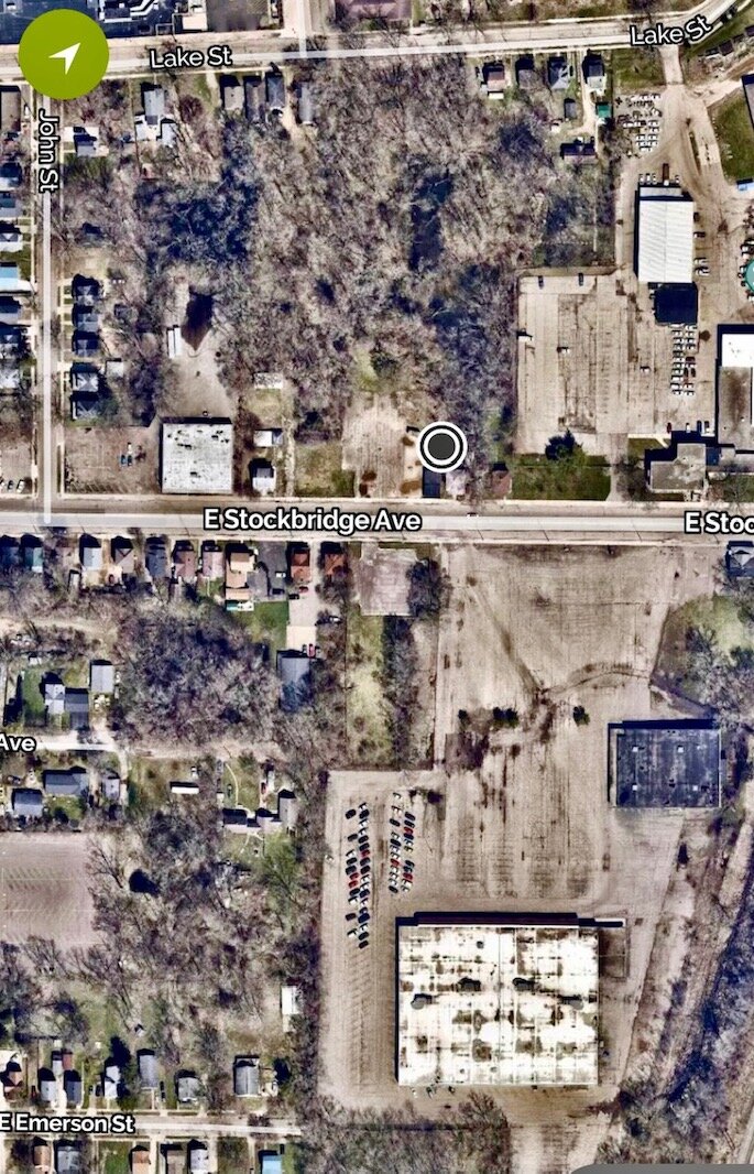 A local organization is negotiating to use part of the 14-acre former site of Kalamazoo County DHS (the white building) to shelter the homeless. Roshaun Heltzel’s salon is at 508 E. Stockbridge Ave., across the street (marked by the black dot).