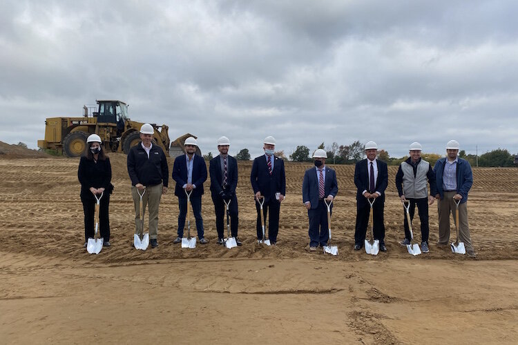 Participants in a groundbreaking ceremony held in late September for the new spec building on Watkins Road