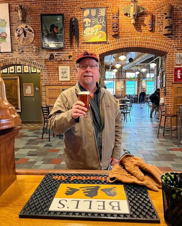Larry Bell has a last glass of beer as president of Bell’s Brewery Inc. in this December 2021 photo inside Bell’s Eccentric Cafe in downtown Kalamazoo.