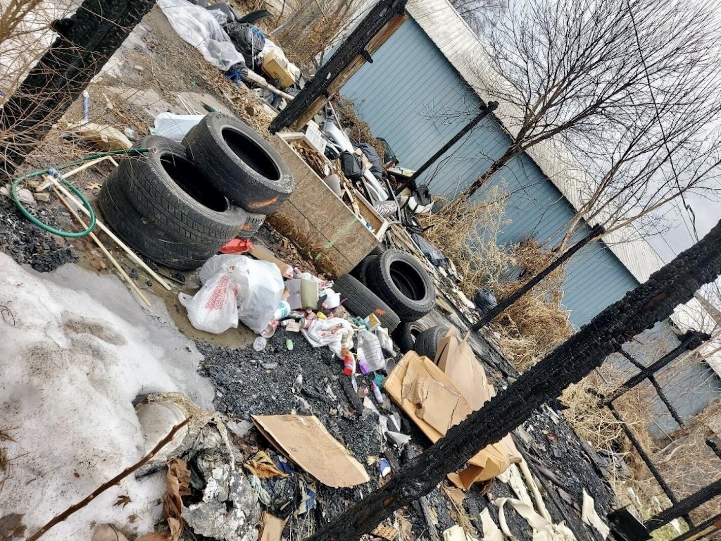 Discarded tires, old pieces of wood and other trash can be seen in the backyard of a house where illegal dumping has occurred in the 800 block of East Stockbridge Avenue. Courtesy of Lanae Newton