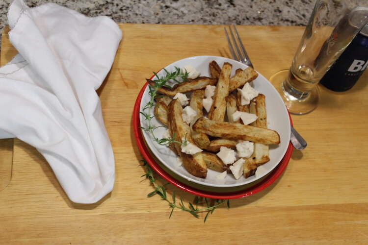 A bowl of poutine before the gravy had been added.