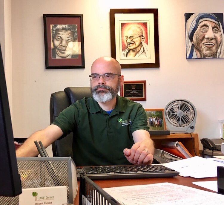 Robert Elchert has paintings he did of Nelson Mandela, Mahatma Gandhi and Mother Teresa mounted on his office wall. Along with Martin Luther King, he says they all practiced nonviolent resistance and promoted unconditional love. 