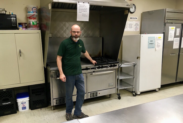 Executive director Robert Elchert stands in the kitchen that the Share Center uses to prepare about 75 meals per day in Battle Creek.