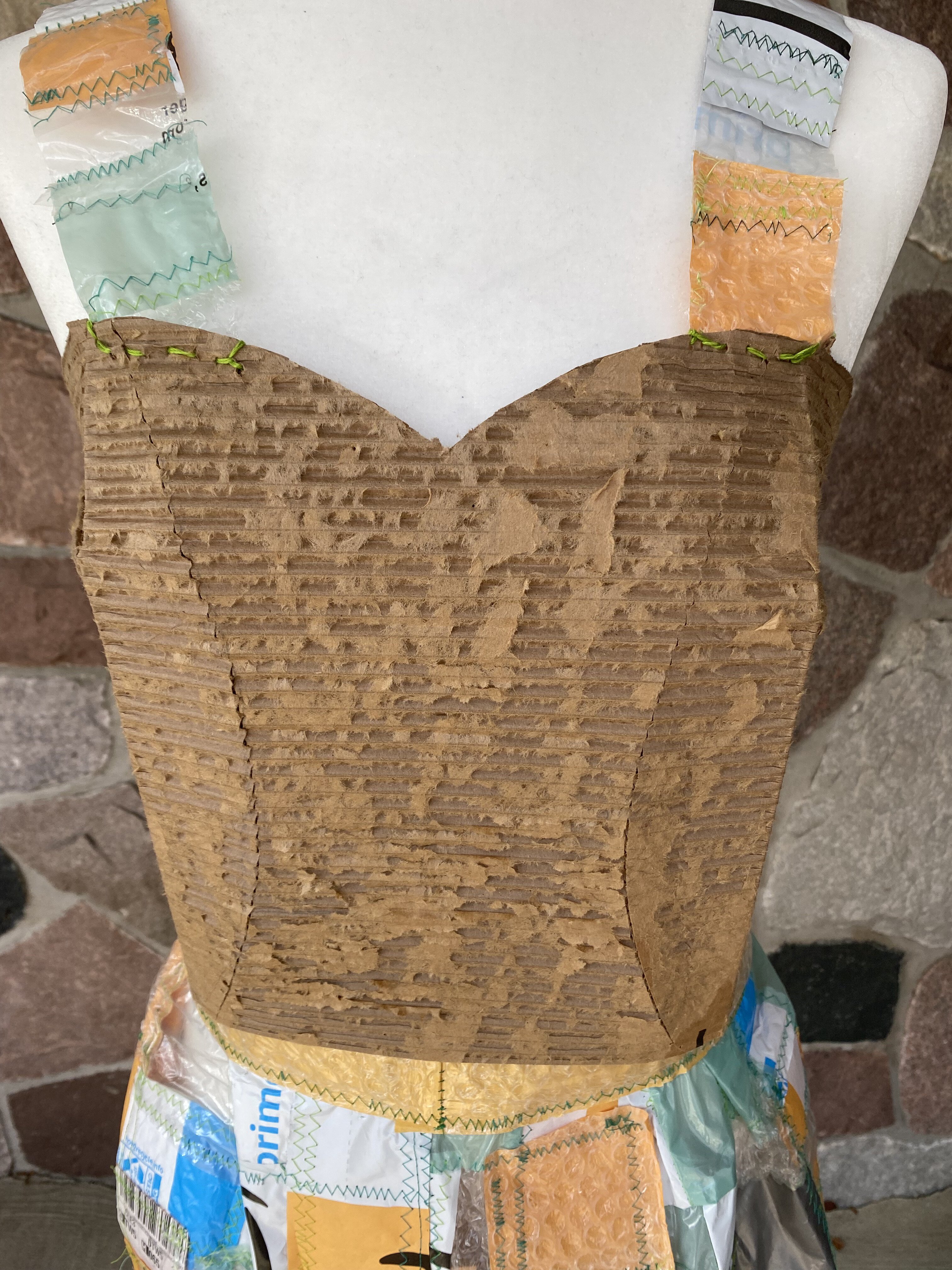 A close-up view of the front of the dress. The straps were made with more strips of patchwork plastic.