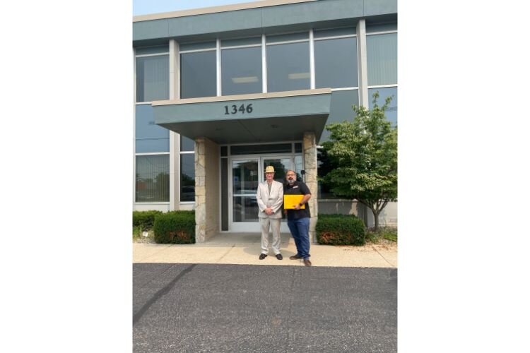 Realtor Mark Haddock (left) and Jose Orozco (right), Co-Exec. Dir. of VOCES, in front of VOCES' new home, Nuestra Casa.