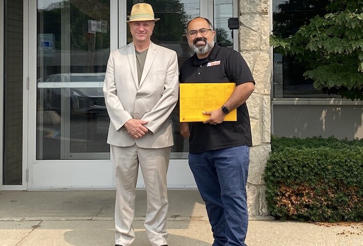 Realtor Mark Haddock (left) and Jose Orozco (right), Exec. Dir. of VOCES, in front of VOCES' new home, Nuestra Casa.