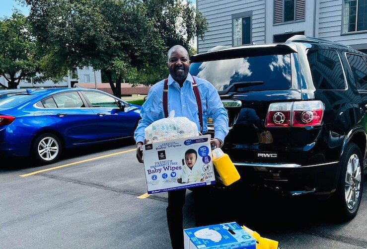 Rev. Joshua Kibezi of the African Community Kalamazoo unloads supplies.