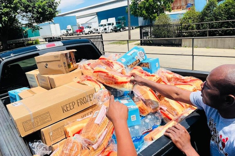 Members of the African Community Kalamazoo with food supplies