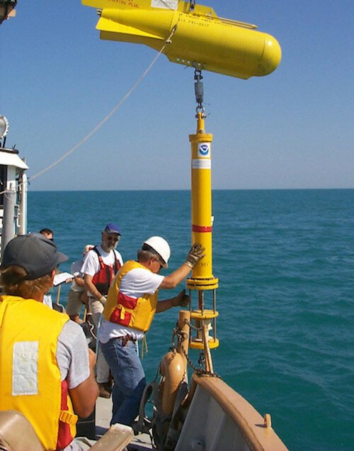 NOAA GLERL scientists deploy a thermistor chain for long-term temperature monitoring in southern Lake Michigan, 1999.