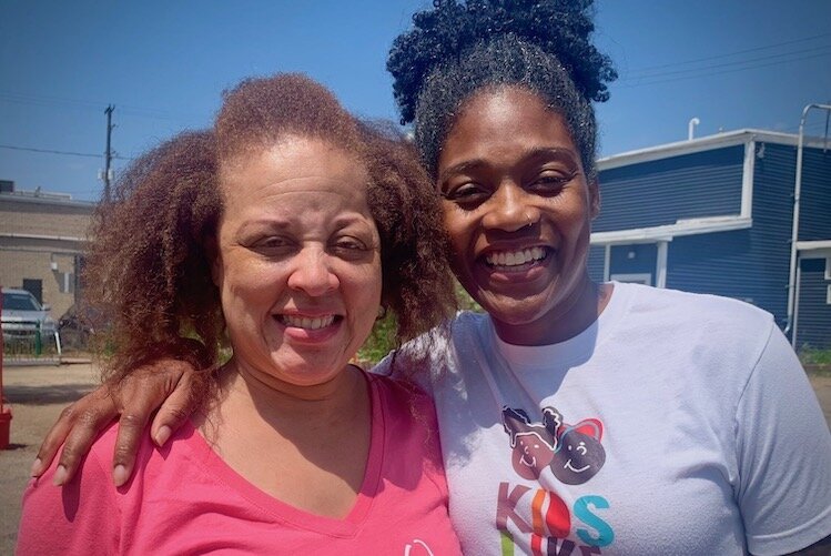 Teresa Baker, founder of Brown Boy, Brown Girl, LLC, left, stands with children’s author author LaTashia Perry in Kalamazoo on July 22, 2023.