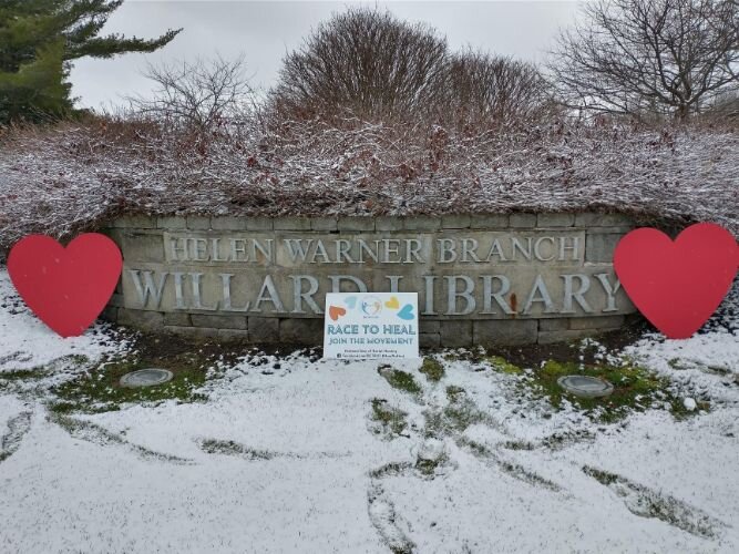 TRHT's Hearts in the Streets and Race to Heal yard signs outside the Helen Warner Branch of Willard Library.