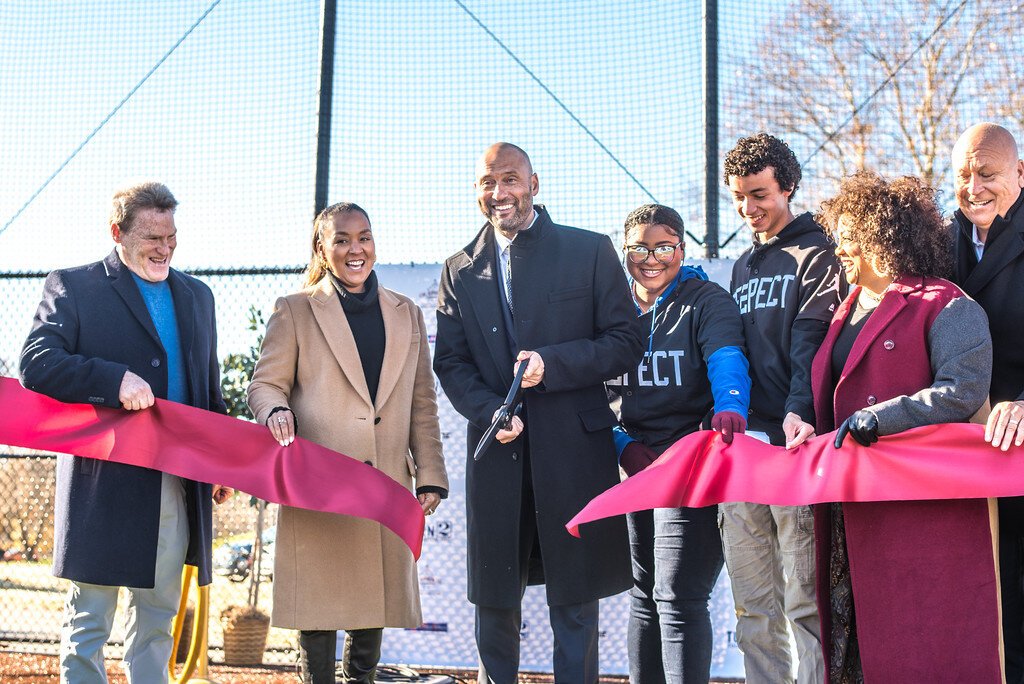 Derek Jeter cuts a ribbon at the dedication of the new baseball/softball complex at Kalamazoo Central High School. From left is: Steve Salem of the Cal Ripken Sr. Foundation; Sharlee Jeter of the Turn 2 Foundation: Jeter's Leaders students Sadaya Ham