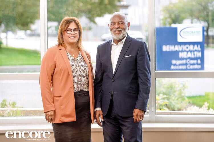 Beth Ann Meints, administrator of clinical services at Integrated Services of Kalamazoo (ISK), and Jeff Patton, ISK CEO, stand inside the lobby of the new Behavioral Health Urgent Care and Access Center.  Encore/Brian K. Powers 