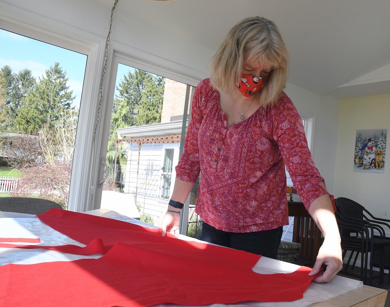 Barb Galonsky lays out a pattern for an isolation gown. 