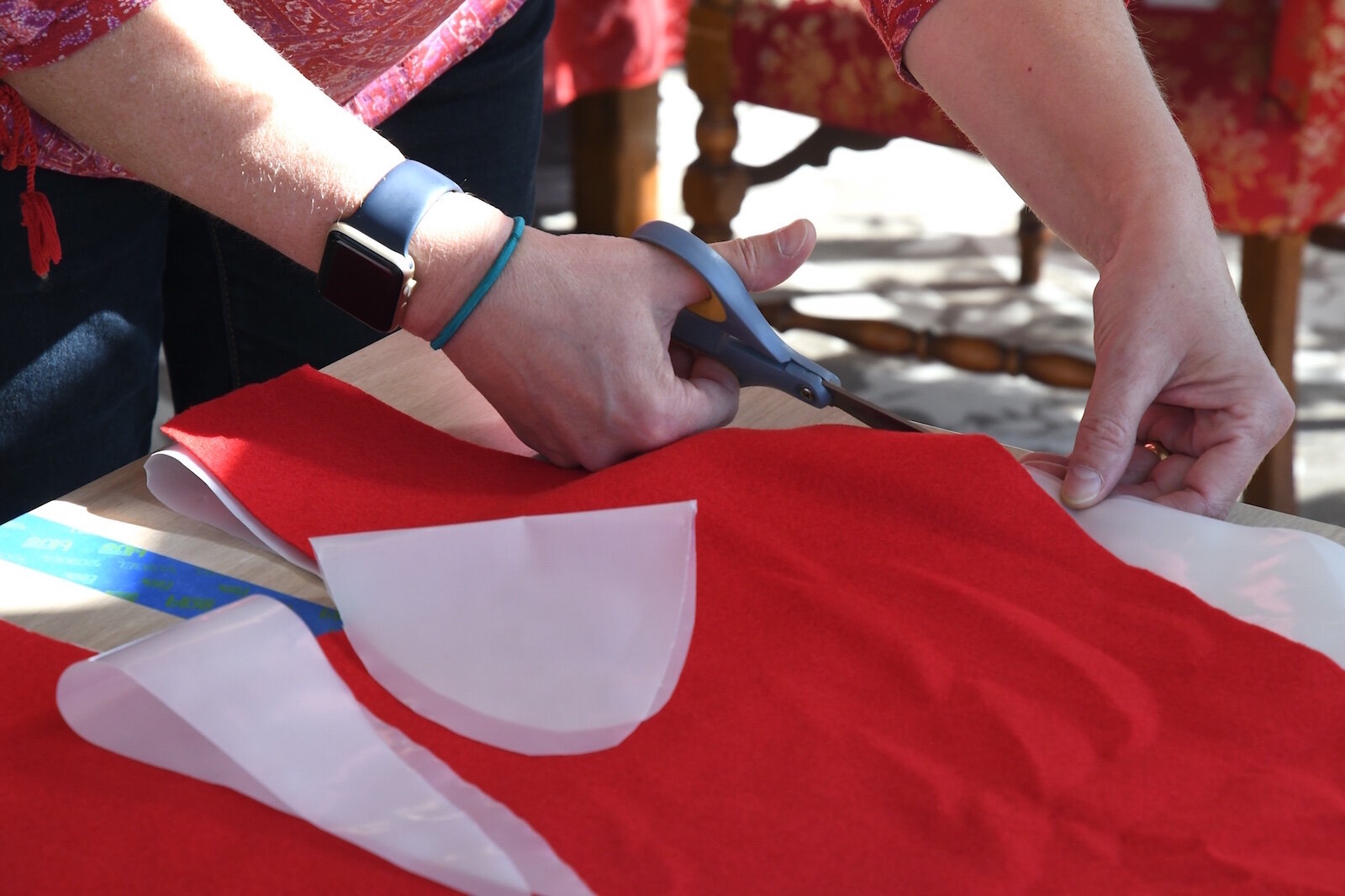 Barb Galonsky cuts out ann isolation gown. 