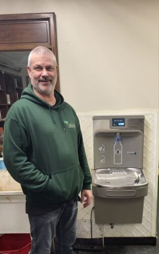 James Van Noty, SHARE employee, stands near a new drinking fountain purchased with ARPA funds.