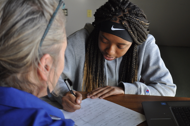 Ke’Asia Shepherd-Friday takes notes on the kinds of questions to ask during an interview for a story. 