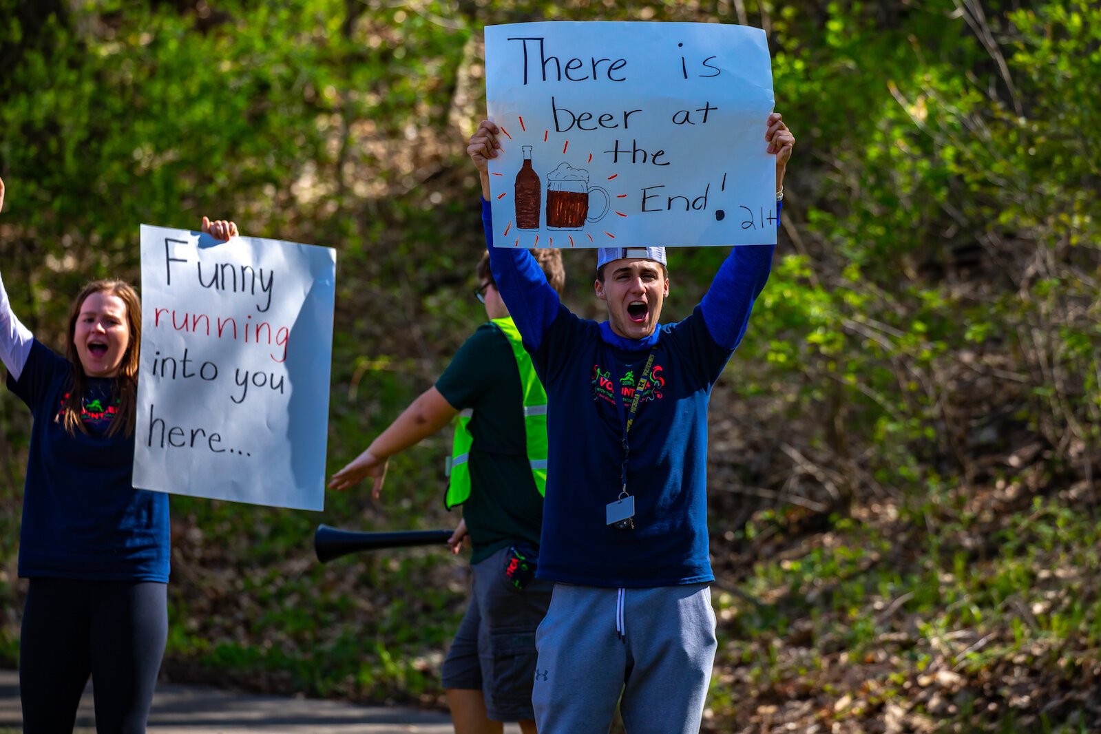 Enthusiastic supporters at the 2019 marathon encourage runners with the promise of a cold beer at the end.